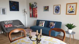 a living room with a couch and a table and chairs at Bastia Appartement 3 chambres vue mer in Bastia