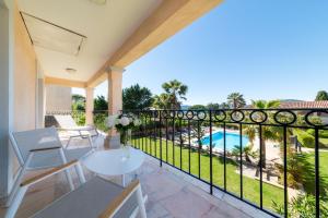 a balcony with a table and chairs and a view of a pool at Hotel Brin d'Azur - Saint Tropez in Saint-Tropez +37 photos