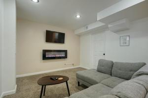 a living room with a couch and a tv at @ Marbella Lane - 4BR Cozy & Comfy Northglenn in Northglenn