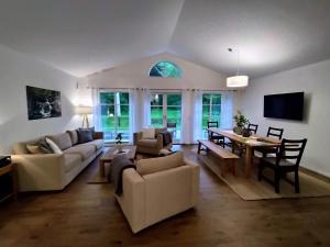 a living room with a couch and a dining room at Ferienhaus Chalet Goldberg in Bad Harzburg
