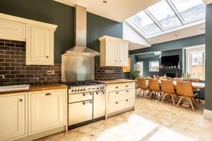 a kitchen with white cabinets and a stove at No1 Apartments & Bedrooms St Andrews - St Mary's in St. Andrews +125 photos