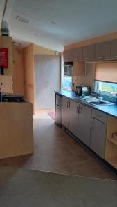 a kitchen with a sink and a counter top at Fairways 21...Turnberry in Girvan