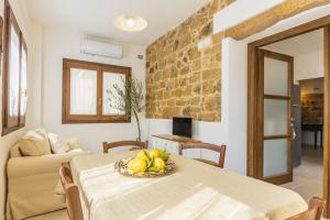 Una habitación con una mesa con un bol de fruta encima. en Casa Amelia sul Mare, en Santa Maria Navarrese