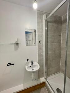 a bathroom with a sink and a shower at Wisteria Studio in London