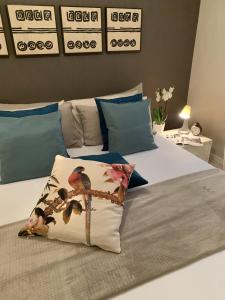 a bedroom with a bed with a bird pillow on it at Villa Luminosa in Torre del Lago Puccini