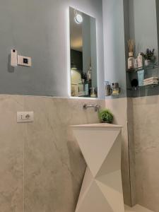 a bathroom with a sink and a mirror at Villa Luminosa in Torre del Lago Puccini