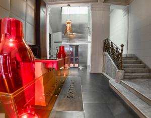 a large red and white staircase leading to a large room at Sixtytwo Hotel in Barcelona