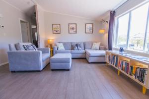 una sala de estar con 2 sofás y un estante para libros. en @ Marbella Lane - 10 Acres Oasis Desert Retreat!, en Joshua Tree