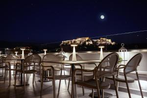 a row of tables with chairs and umbrellas at MiraMe Athens Boutique Hotel-House of Gastronomy in Athens