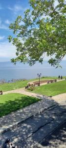 a park with benches and the ocean in the background at Guest House Tony in Nesebar