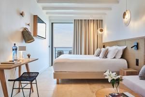 a hotel room with a bed and a desk at Les Roches Brunes in Collioure