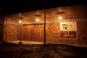 a room with a wooden door and a poster on the wall at Akagera Transit Lodge in Akagera