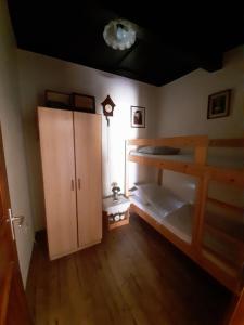 a room with two bunk beds and a cabinet at Márfi vendégház in Magyarszerdahely