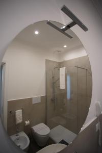 a bathroom with a shower and a toilet and a sink at Palazzo Bibbi - Rooms to Live in Reggio Calabria