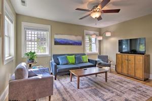 a living room with a couch and a tv at Downtown Brevard Home Walk to Bars and Breweries! in Brevard