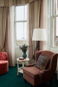 a living room with a chair and a lamp at Marine North Berwick in North Berwick