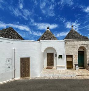 a white building with two spires on top of it at Trullo Zia Nina in Alberobello