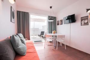 a living room with a couch and a table at Amazing Sesimbra Duplex close to the beach by Trip2Portugal in Sesimbra