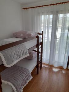 Postel nebo postele na pokoji v ubytování Apartmani I & J Šerić
