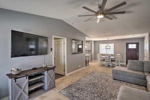 a living room with a flat screen tv and a couch at Updated Home with Outdoor Oasis, 2 Mi to Lake! in Lake Havasu City