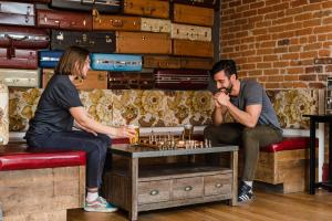 a man and a woman playing a game of chess at Hostel Fish in Denver