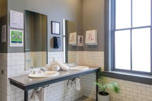
a bathroom with a sink, toilet, and mirror at Hostel Fish in Denver
