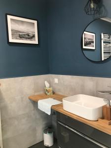 un bagno con un lavandino bianco e uno specchio di Apartament Holenderski z prywatnym miejscem postojowym w garazu a Koszalin Altre 5 foto