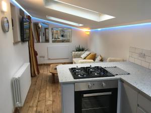 a kitchen and living room with a stove top oven at The Bees Knees @ Redhill Grange in Monmouth