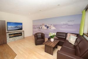 a living room with a couch and a fireplace at Ferienwohnung "Mein Alpenjuwel" in Filzmoos