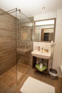 a bathroom with a sink and a shower at Ferienwohnung "Mein Alpenjuwel" in Filzmoos +23 photos