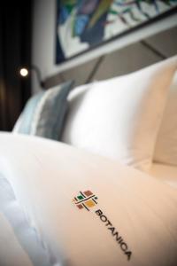 Postel nebo postele na pokoji v ubytování Hotel Botanica
