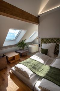 a bedroom with a large bed and a bath tub at Hochhubergut in Aschach an der Steyr