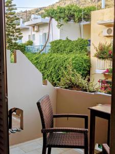 a balcony with a table and two chairs and plants at Pension Irene in Sougia