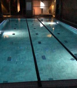 a swimming pool in a building at night at Hostal Sant Marti in Puig-reig