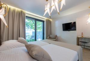 เตียงในห้องที่ Bošket Luxury Rooms