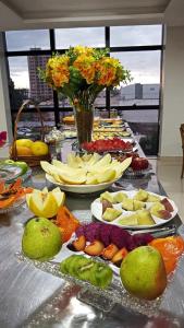 a long table with many plates of fruit on it at Hotel Universal in Santarém