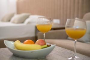2 Gläser Orangensaft und eine Schale Obst in der Unterkunft Bošket Luxury Rooms in Split