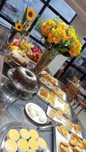 a table with a buffet of food on it at Hotel Universal in Santarém