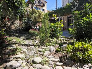 a garden with rocks and plants in front of a house at Pension Irene in Sougia
