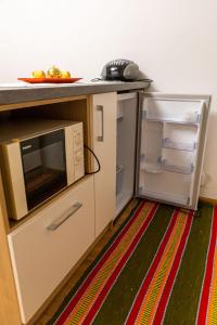 a toy kitchen with a microwave and a refrigerator at Privat Bajka 2 in Spišské Bystré