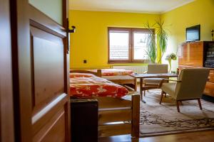 a bedroom with a bed and a table and chairs at Privat Bajka 2 in Spišské Bystré