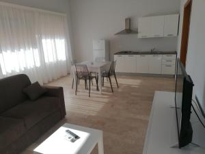 a living room with a couch and a table at Zibibbo Beach Apartments - Trapani in Trapani