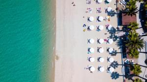 an overhead view of a beach with umbrellas and the ocean at Tridente Mare Apart Hotel in Pefkohori