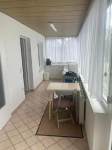 an office with a desk and a table with a chair at Redewischer Str.8 in Boltenhagen