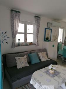 a living room with a couch and a table at Big Blue - Xenija (Veliko Plavetnilo - Ksenija) in Metajna