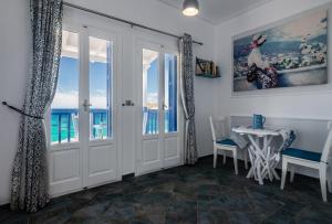 a dining room with a table and a view of the ocean at Aphrodite by Akroploro in Pollonia