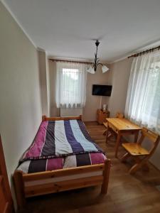 Posteľ alebo postele v izbe v ubytovaní Dom gościnny Krasne