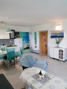 a living room with a couch and a table at Big Blue - Xenija (Veliko Plavetnilo - Ksenija) in Metajna