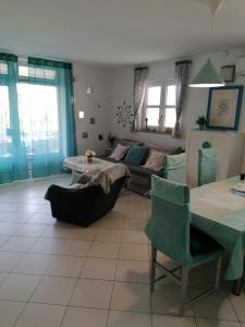 a living room with a couch and a table at Big Blue - Xenija (Veliko Plavetnilo - Ksenija) in Metajna