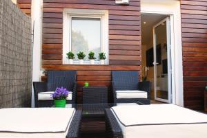 two tables and chairs on a patio with a window at Green Home in Santiago de Compostela